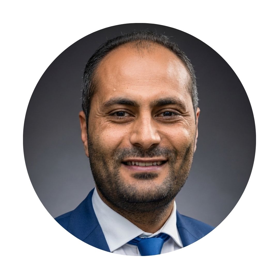 Ghmkin Hassan headshot with dark background.