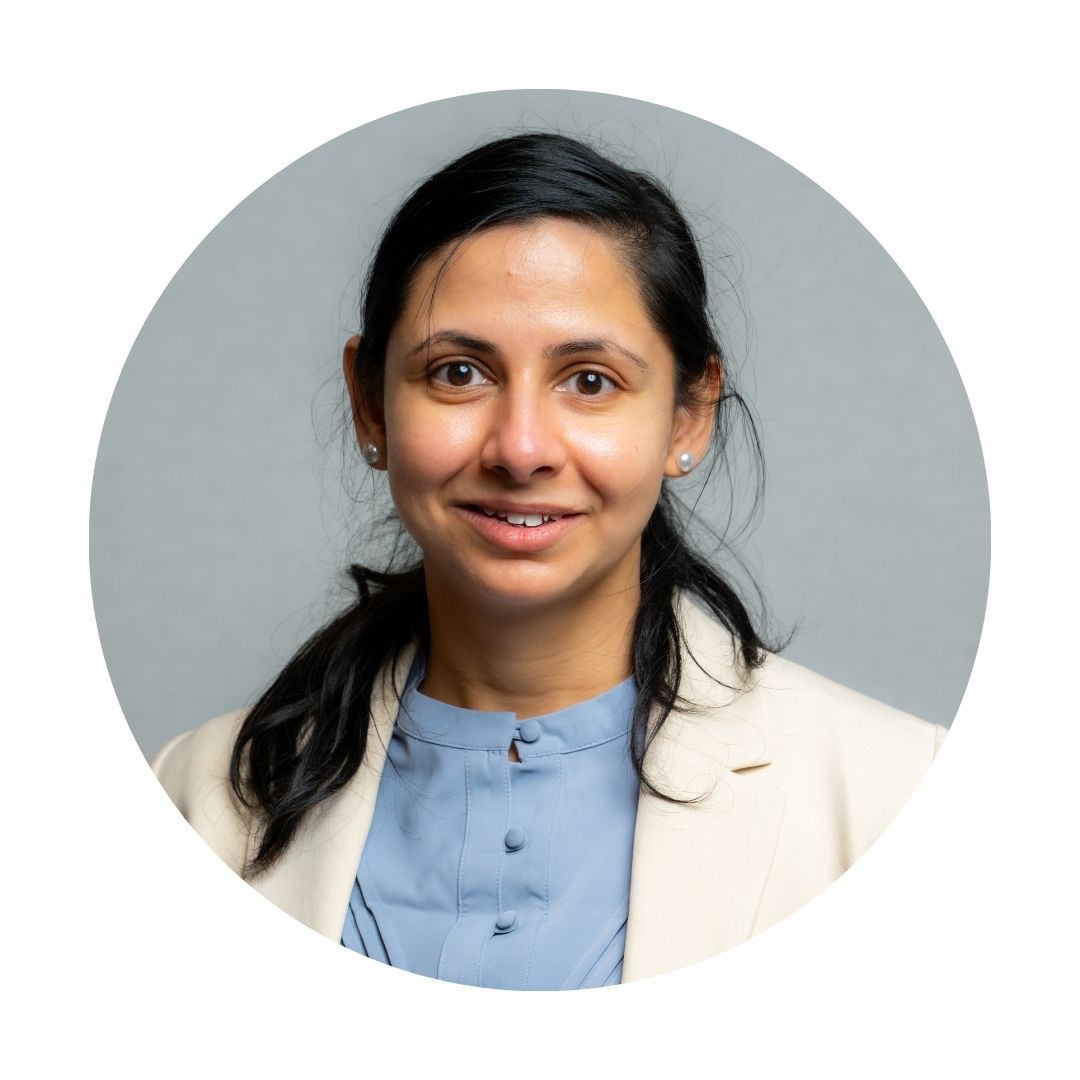 Headshot of Diviya Sinha in a white blazer.
